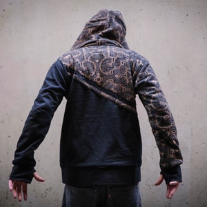 May include: A black hooded sweatshirt with a geometric pattern on the back and sleeves. The hoodie has a zipper closure and a drawstring hood.