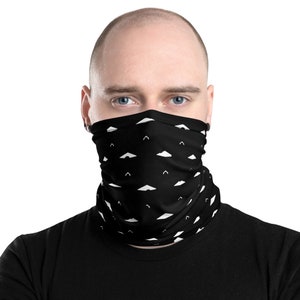 May include: Black face covering with a repeating white cloud pattern. The neck gaiter is worn around the neck and covers the lower face. The fabric is soft and appears to be made of a breathable material.
