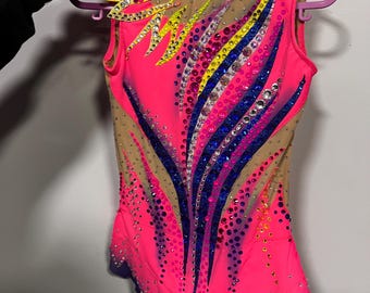 Può includere: Un body rosa acceso con schiena e maniche in rete color carne, ornato di strass colorati e motivi decorativi gialli, blu e viola. Ideale per la ginnastica o la danza.