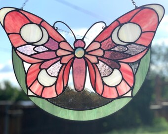 Art nouveau butterfly stained glass in pinks and green with center faceted jewel