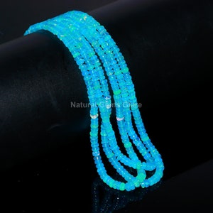 Puede incluir: Una hebra de cuentas de ópalo azul. Las cuentas son redondas y tienen un acabado liso y pulido. La hebra mide aproximadamente 45 cm de largo.