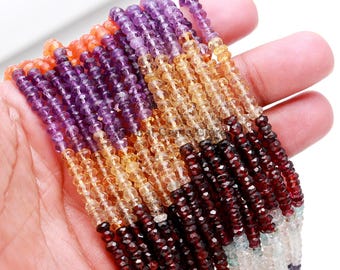 May include: A strand of faceted gemstone beads in shades of purple, orange, yellow, red, and green. The beads are small and uniform in size, and they are strung on a clear thread.