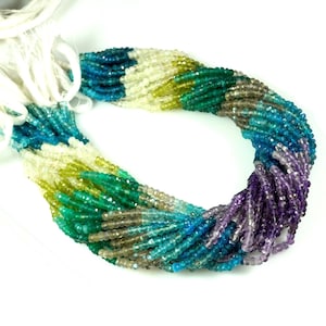 Peut inclure: Un brin de perles de pierres précieuses facettées dans des tons de violet, bleu, vert et jaune. Les perles sont enfilées sur un fil blanc et sont prêtes à être utilisées pour la fabrication de bijoux.