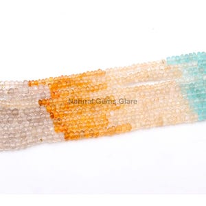 May include: A strand of beads with a gradient of colours, starting with light brown, transitioning to orange, and ending with light blue.