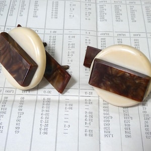 May include: Vintage ivory cufflinks with a rectangular brown marbled accent. The circular cufflinks have a brown marbled rectangular centre and a brown marbled bar.