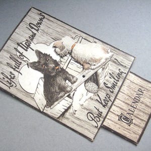 Dogs calendar 1957 | Dogs on a seesaw | Scottie dog | Terrier | Dog calendar | Dog cartoon | See saw calendar | Smethwick | 1950's calendar