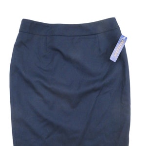 May include: A dark blue pencil skirt with a waistband and a label that says "Revolution" in gold lettering.