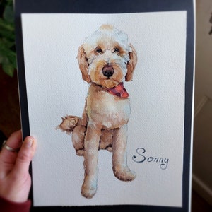 K&ouml;nnte beinhalten: Aquarellmalerei eines hellbraunen Hundes mit einem roten Halstuch. Der Hund sitzt und schaut den Betrachter an. Das Bild ist mit "Sonny" signiert.
