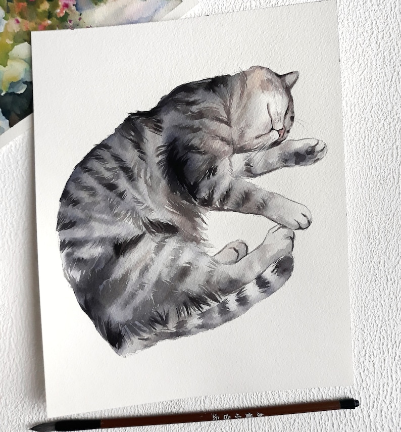 May include: Watercolour painting of a grey tabby cat sleeping on its side. The cat is curled up with its head resting on its paws.