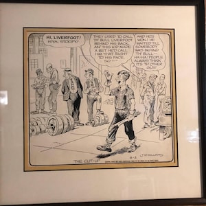 May include: Framed black and white comic strip titled "The Cut-Up" by J.R. Williams. The cartoon depicts a scene with several men and a central figure speaking. Text bubbles contain dialogue. The image is in a black frame.