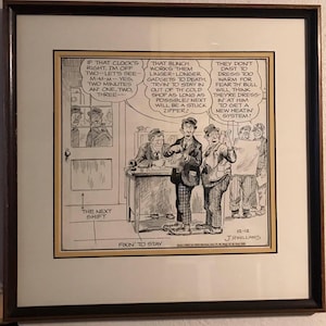 May include: Framed black and white cartoon print. The image features several men in a shop setting, with speech bubbles containing text. The text includes phrases like "The Next Shift" and "Fixin' to Stay". The artist's signature and date are visible.