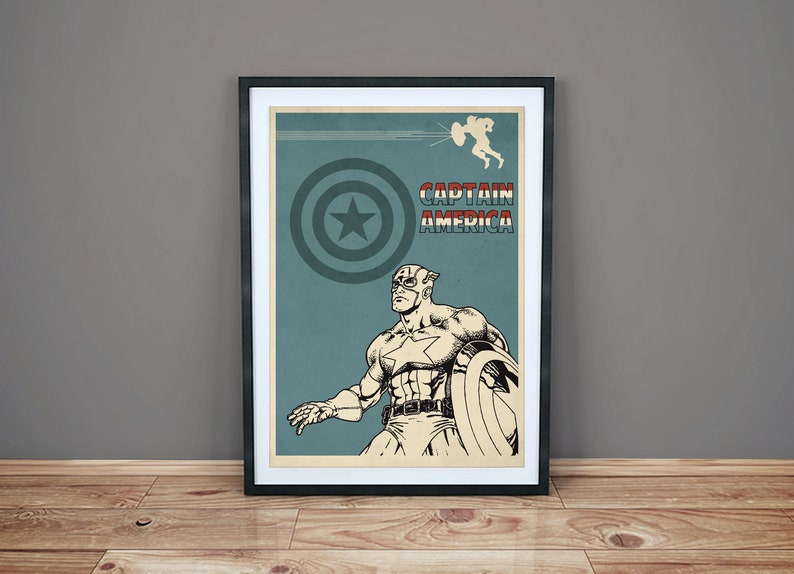 May include: A vintage-style poster featuring Captain America in a blue, red, and white color scheme. The poster has the text "Captain America" in red and white letters. The poster is framed in black.