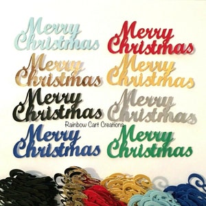 May include: Assortment of "Merry Christmas" cutouts in various colors, including blue, red, gold, silver, black, and green. The cutouts are made of a shiny material and have a festive, celebratory feel.