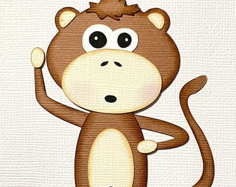 May include: A brown cartoon monkey with big eyes and a surprised expression. The monkey is standing with its right arm raised and its left arm bent at the elbow. The monkey has a long tail that curls around its body.