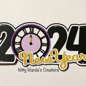 May include: Black and gold 2024 New Year sign with a purple clock face. The sign is decorated with a gold glitter finish and the text "New Year" is in a script font.