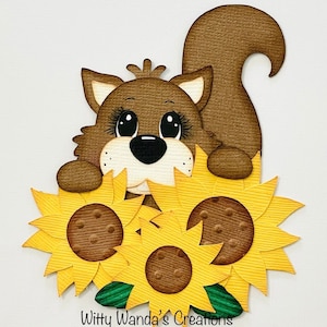 May include: A brown squirrel with big eyes and a fluffy tail peeking out from behind three yellow sunflowers. The sunflowers have brown centers and green leaves.