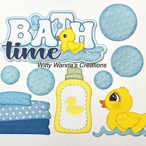 May include: A whimsical papercraft design with the words "BATH time" and a yellow rubber ducky. The design includes blue bubbles, a bottle of baby wash, and a stack of blue towels. The design is perfect for baby shower decorations.