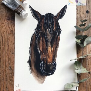 May include: Watercolor painting of a brown horse's head with a black mane and a white background.