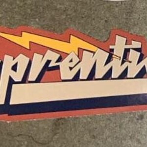 May include: A red, white, and blue sticker with the word "Apprentices" in a stylized font. A yellow lightning bolt is behind the text.