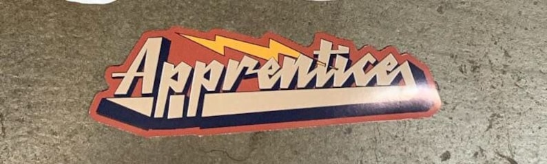 May include: A red, white, and blue sticker with the word "Apprentices" in a stylized font. A yellow lightning bolt is behind the text.