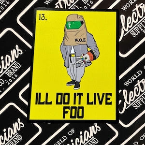 May include: A yellow sticker with a cartoon character wearing a brown bag over their head and a gray suit. The character is holding a small object in their hand. The text "ILL DO IT LIVE FOO" is printed in black letters on the sticker.