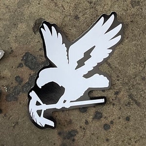 May include: White silhouette of a bird with outstretched wings holding a stylized branch in its talons. The bird is facing the right side of the image.