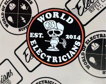 May include: A black and white sticker featuring a skull wearing a hat and holding a wrench. The sticker reads "World of Electricians Est. 2014" in a white circle with an orange outline.