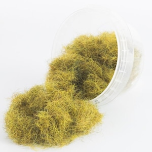 Może przedstawiać: Pojemnik z żółto-zielonymi włóknami statycznej trawy do modelarstwa kolejowego lub miniaturowego krajobrazu.