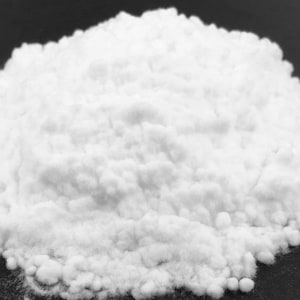 May include: A close-up of a white powder, likely baking soda, on a black surface.