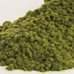 Może przedstawiać: Stos zielonej trawy statycznej, popularny materiał do modelarstwa kolejowego i miniaturowego krajobrazu.