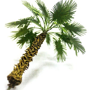 May include: A green artificial palm tree with a brown textured trunk. The tree is isolated on a white background.