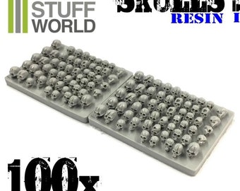 May include: Two sheets of gray resin with 100 small, detailed skulls. The sheets are labeled "Skulls Resin 1" and "Green Stuff World".