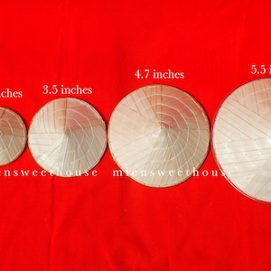 May include: Five conical hats of varying sizes, ranging from 1.9 to 5.5 inches in diameter, are displayed against a vibrant red background. The hats are made of woven straw and are arranged in a row. The text "miensweethouse" is visible.
