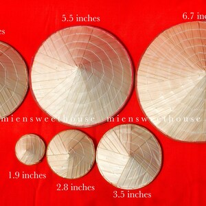 May include: A collection of conical straw hats of varying sizes, ranging from 1.9 inches to 6.7 inches in diameter, arranged on a red background. The hats are made of woven straw and feature a pointed crown and a wide, circular brim. The text "miensweethouse" is visible.