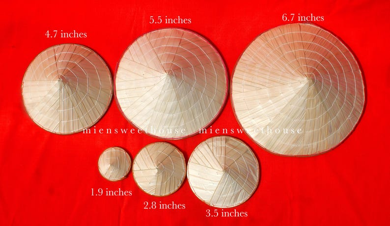 May include: A collection of conical straw hats of varying sizes, ranging from 1.9 inches to 6.7 inches in diameter, arranged on a red background. The hats are made of woven straw and feature a pointed crown and a wide, circular brim. The text "miensweethouse" is visible.