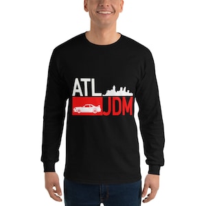 May include: Black long-sleeve t-shirt with a red and white graphic design featuring a white silhouette of a car, the text "ATL JDM", and a white silhouette of the Atlanta skyline.