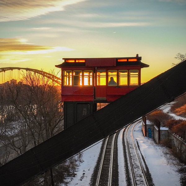 Passengers get ready to disembark the Duquesne Incline as the sun shines through the cable car windows.