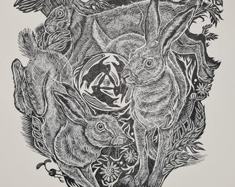 May include: Black and white linocut print featuring several hares surrounded by foliage, mushrooms, and flowers. The artwork has a detailed, textured style with a central circular design. The overall theme is nature and wildlife.