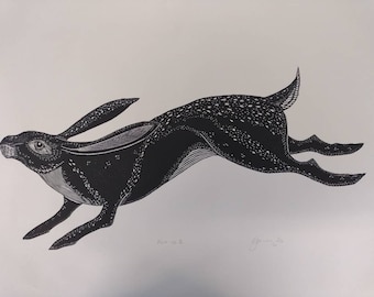 May include: Black and white linocut print of a stylized rabbit running. The print is signed and numbered.