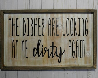 Handcrafted white washed wooden wall hanging with 'The dishes are looking at me dirty again' quote in black vinyl
