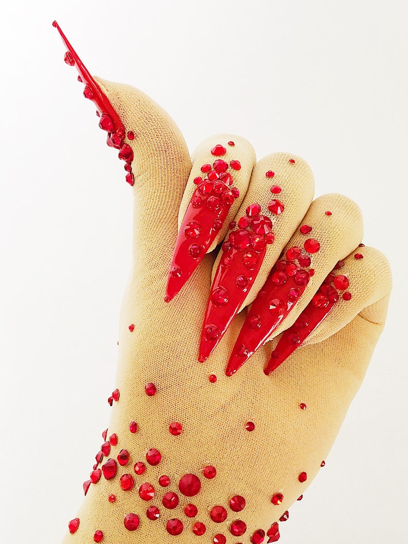 Sheer faux skin nail gloves with red stiletto nails and red glass rhinestones for drag queens burlesque performers and Dancers