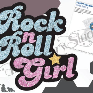 May include: Glitter iron-on transfer design for t-shirts featuring the text "Rock n Roll Girl" in blue and pink glitter with a gold star.