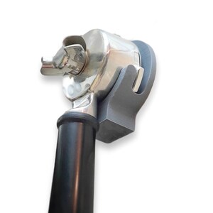 May include: A chrome-colored, mechanical device with a black handle and a gray support structure. The device has a complex design with multiple components and a shiny, reflective surface. The handle is cylindrical and tapers towards the base.