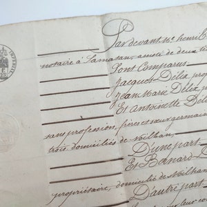 Może przedstawiać: Zbliżenie na historyczny dokument napisany po francusku. Dokument jest datowany na 16 dzień miesiąca i podpisany przez Henri Broyeu, notariusza w Tamasan. Dokument wymienia Jacquesa Delixa, Jeana Marie Delixa i Antoinette Delix jako właścicieli i mieszkańców Voilban.