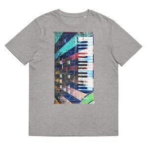 May include: A grey t-shirt with a colorful graphic of a synthesizer keyboard. The keyboard has a white and black key layout and is surrounded by a colorful geometric pattern.