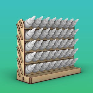 May include: A light-colored wooden storage rack featuring five horizontal shelves designed to hold multiple small white plastic squeeze bottles. The rack has a side panel with a series of angled cutouts and a flat base for stability.