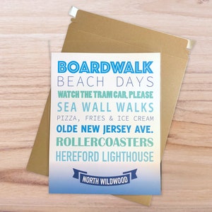 May include: A blue and white postcard with a gradient background. The text on the postcard reads "Boardwalk Beach Days", "Watch the Tram Car, Please", "Sea Wall Walks", "Pizza, Fries & Ice Cream", "Olde New Jersey Ave.", "Rollercoasters", "Hereford Lighthouse", and "North Wildwood".