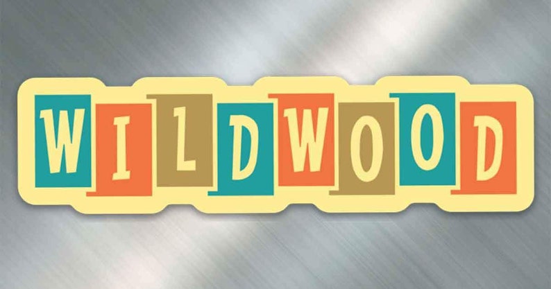 May include: A yellow and white sticker with the word "WILDWOOD" in colorful block letters. The letters are in shades of teal, orange, brown, and yellow.