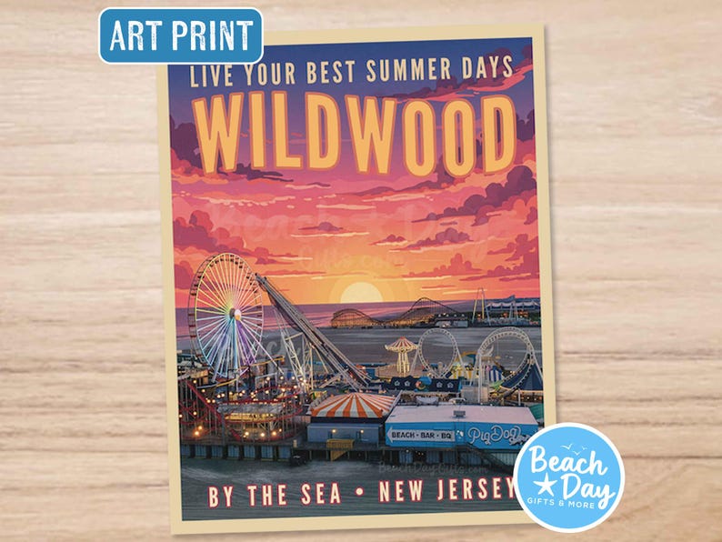 May include: Art print featuring a vibrant sunset over Wildwood, New Jersey. The image showcases a Ferris wheel, roller coasters, and seaside buildings. Text includes "Live Your Best Summer Days" and "By The Sea".