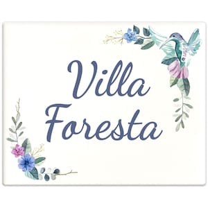 Puede incluir: Un cartel blanco con diseños florales azules en acuarela y un colibrí. El cartel dice "Villa Foresta" en letras cursivas azules.